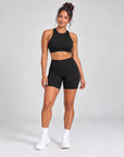 Black Sculpt Open-Back Crop Top styled with matching Sculpt Bike Shorts, full length front