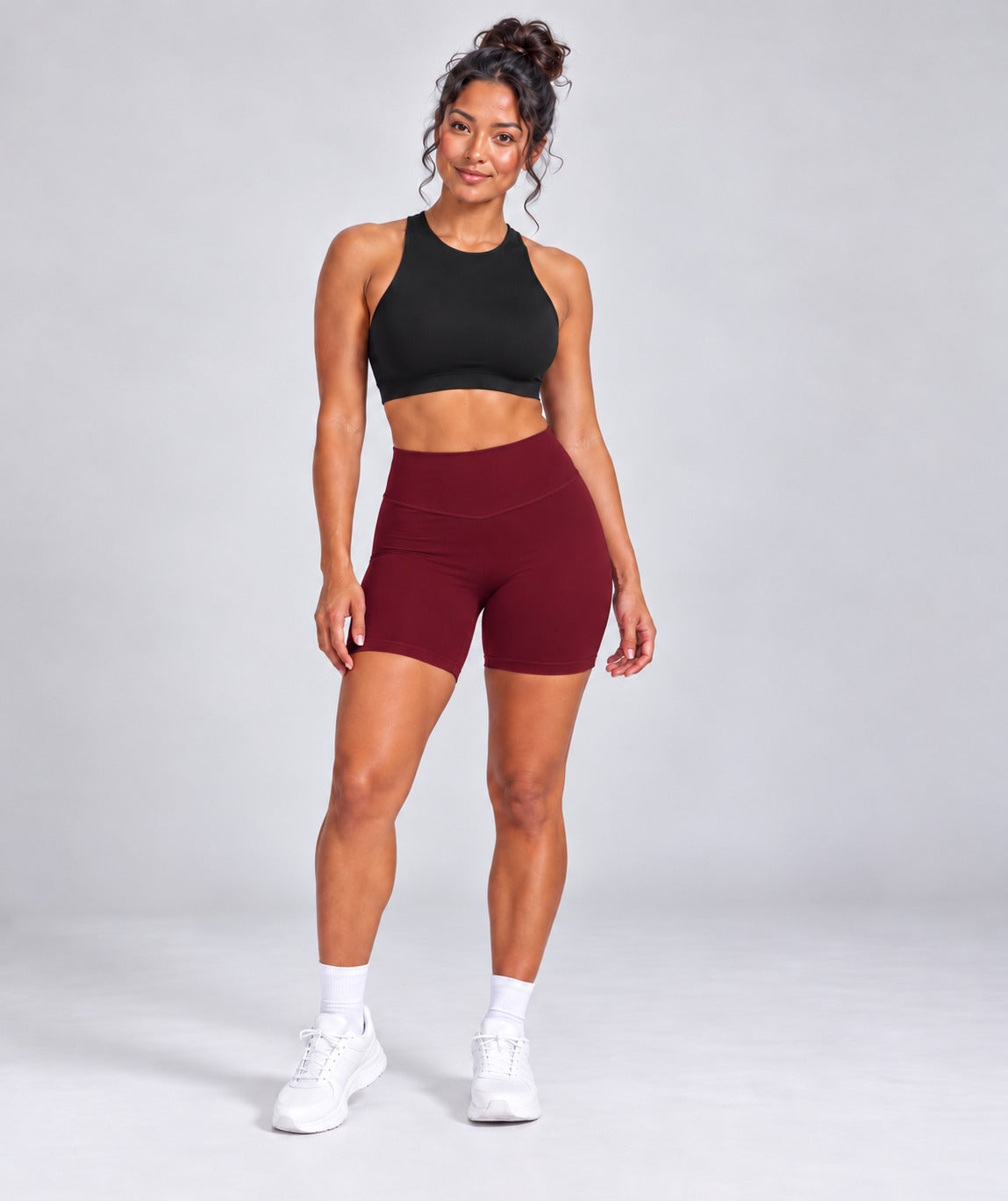 Sculpt Bike Shorts in burgundy styled with black crop top, full length front view