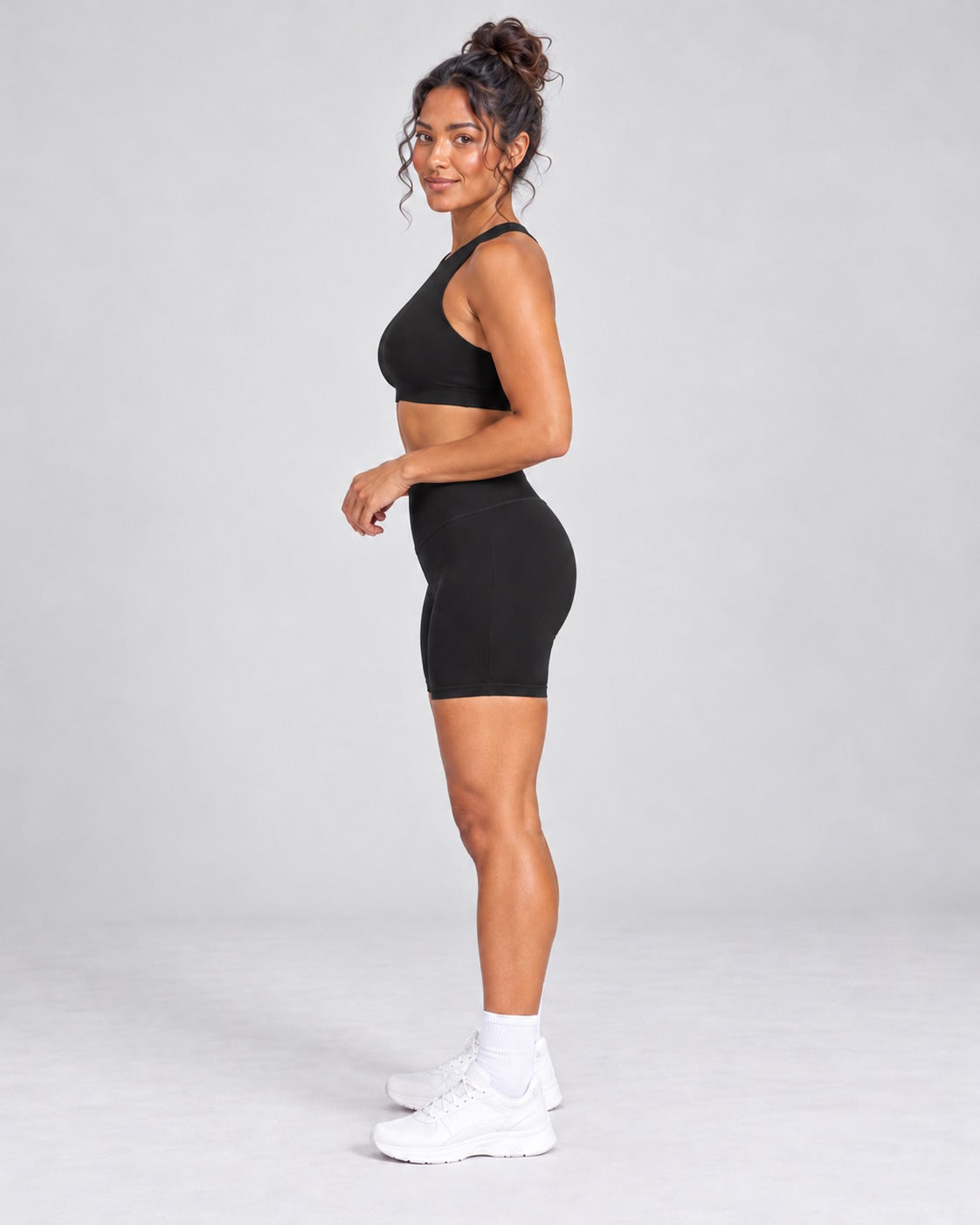 Black crop top and bike shorts set, full length side view