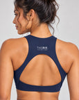 Navy crop top back view showing racer back, teardrop cut-out and THE FIT. COLLECTION logo